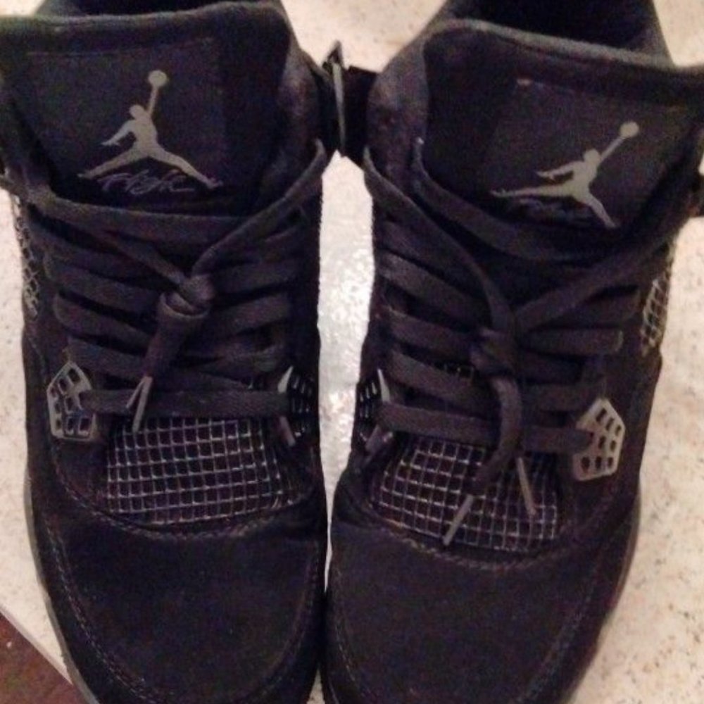 Black cat Jordan 4s